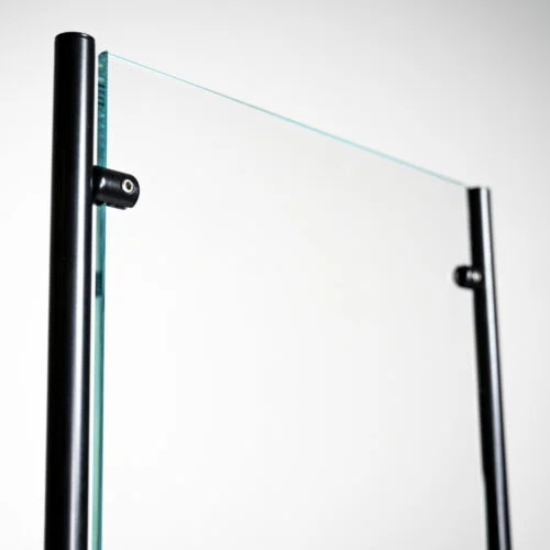 Tall glass protective barrier with black posts.